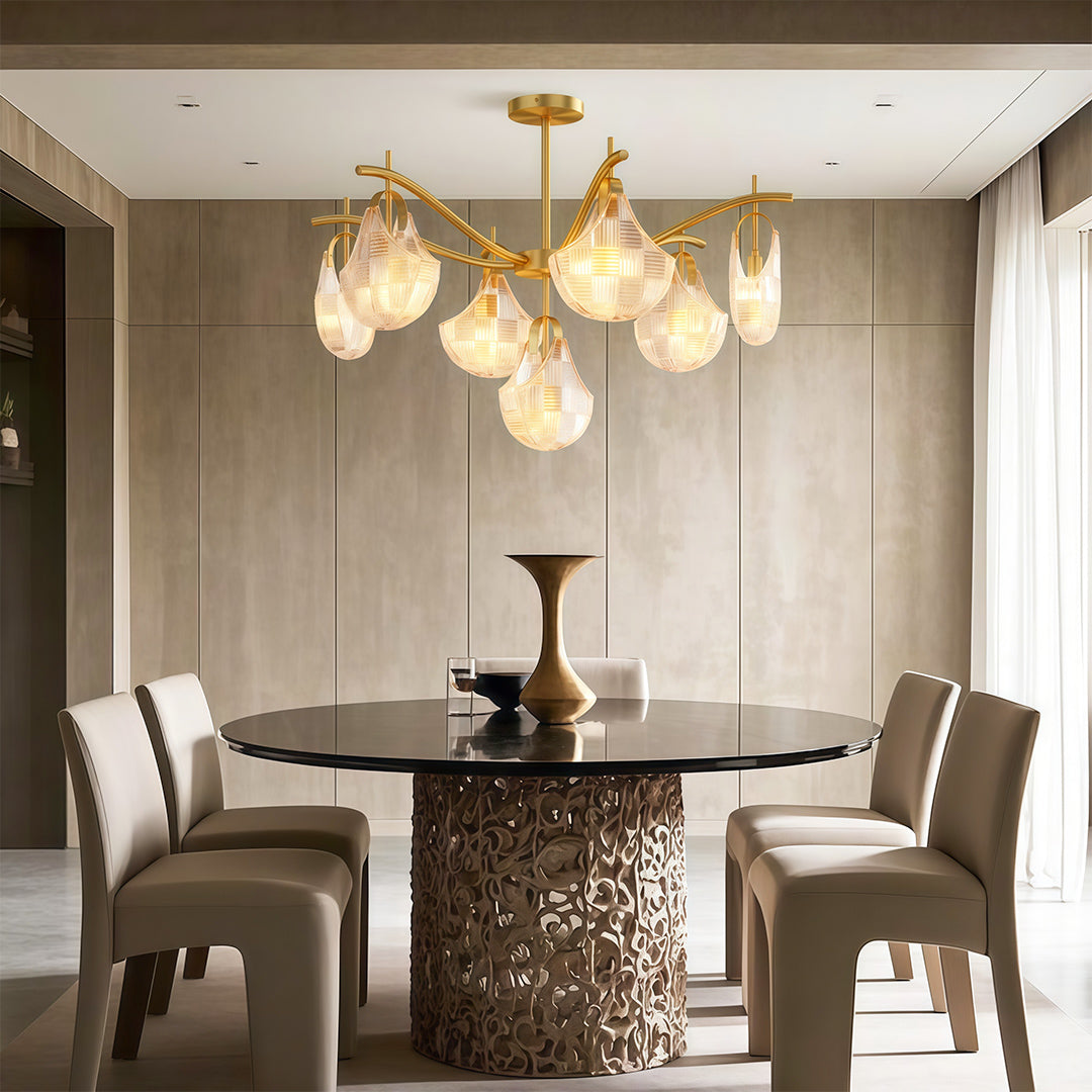 Modern luxury chandeliers lighting contemporary dining space with fluted table base