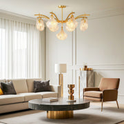Modern luxury chandeliers illuminating elegant living room with neutral sofa and gold accents