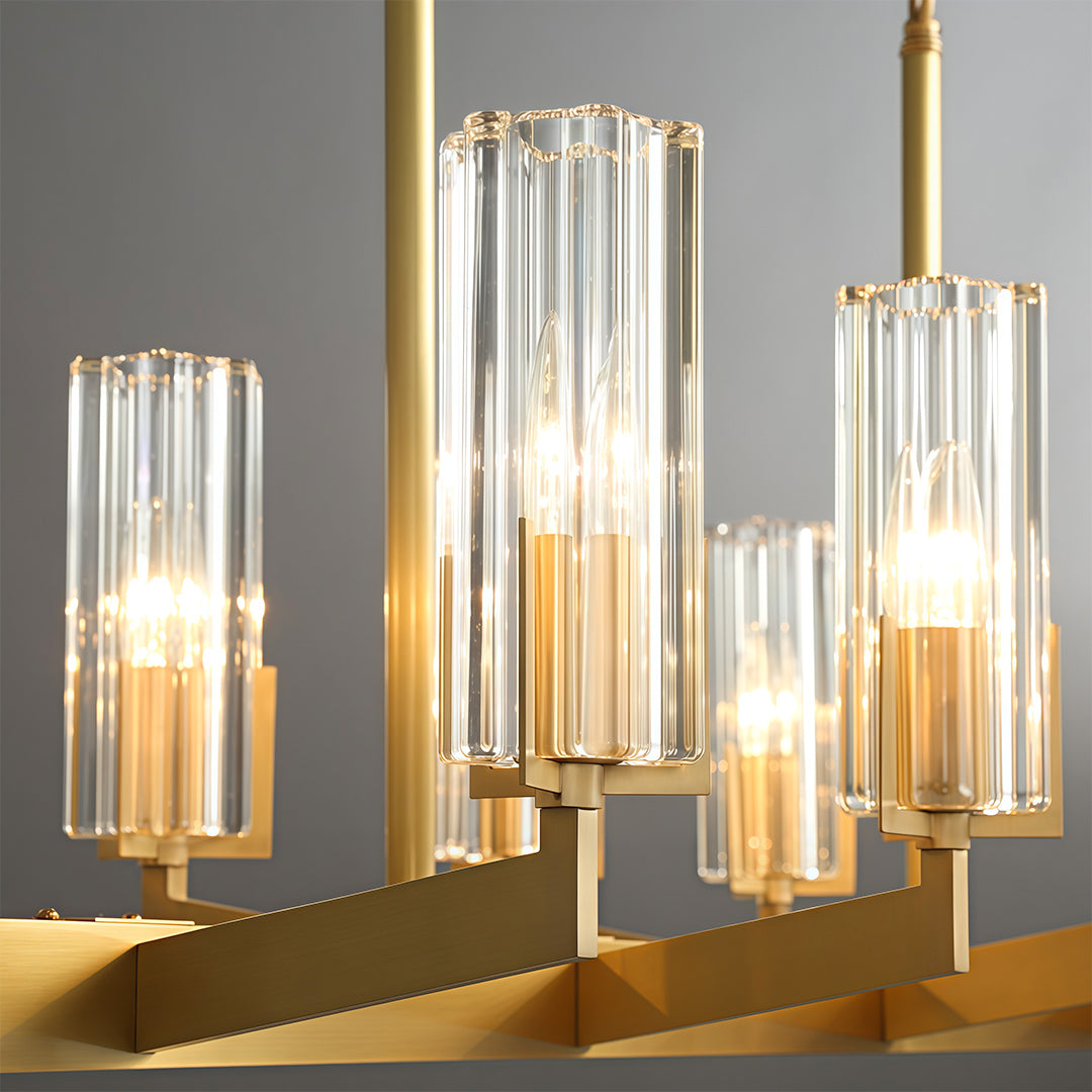 Modern luxury chandeliers creating golden glow in sophisticated dining space with brass accents