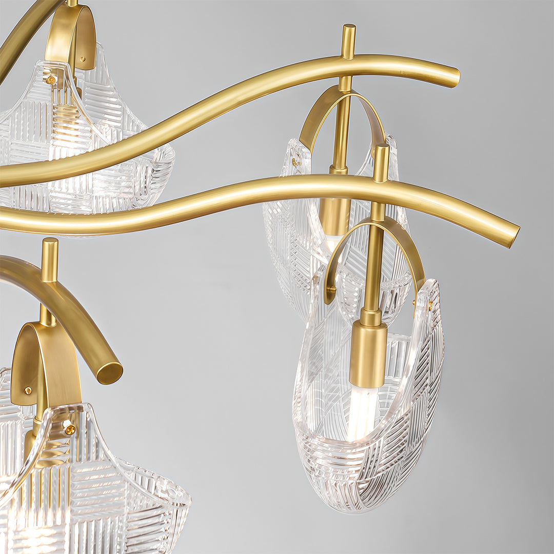Modern luxury shell chandelier light close up showcasing brass arms and shell glass pendant detail.