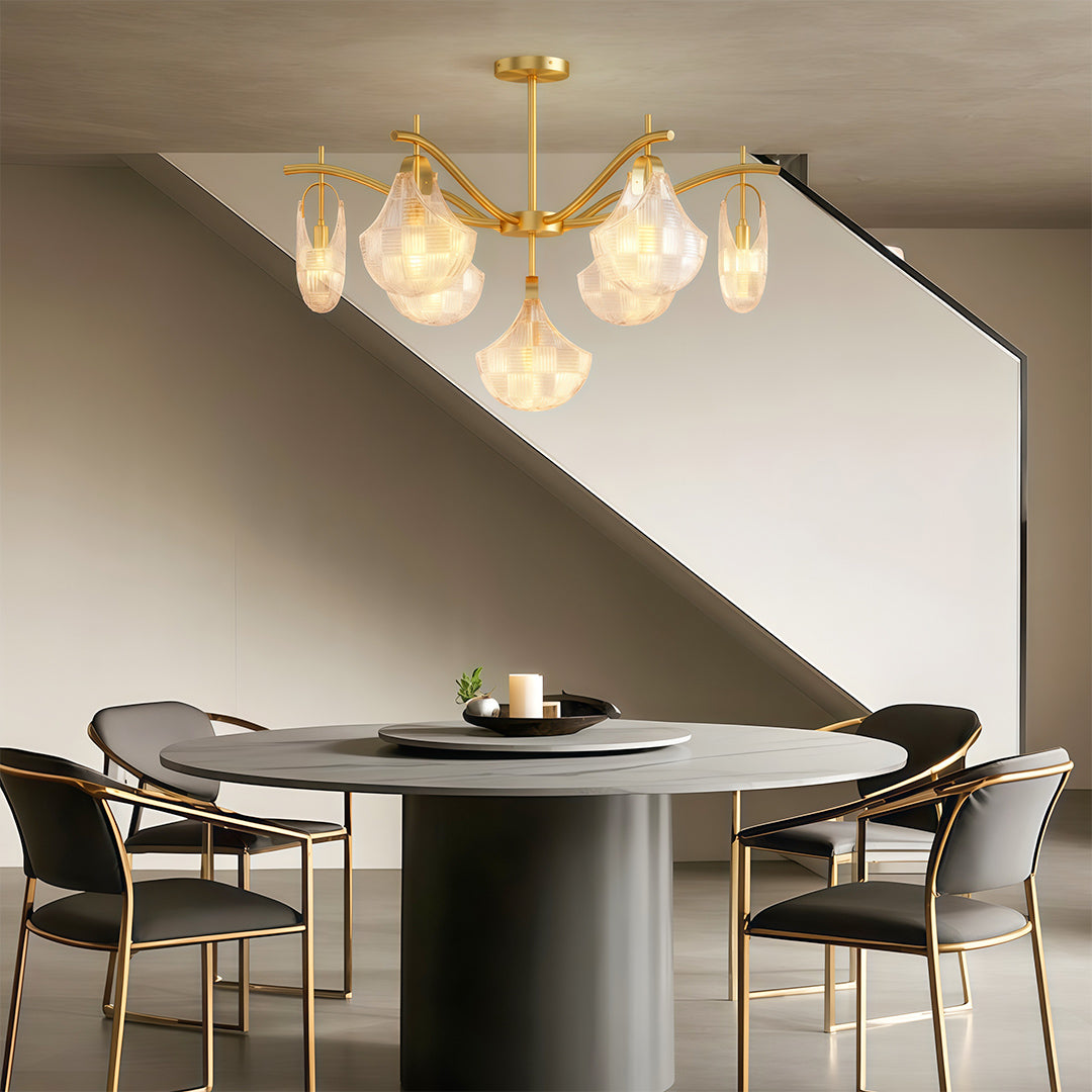 Shell chandelier light above contemporary dining table with black chairs and modern art.