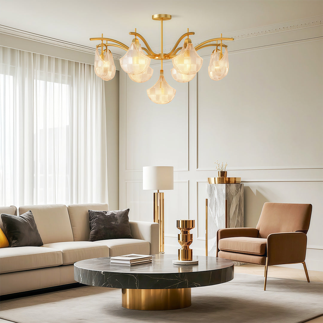 Modern luxury shell chandelier light illuminating elegant living room with neutral sofa and gold accents.
