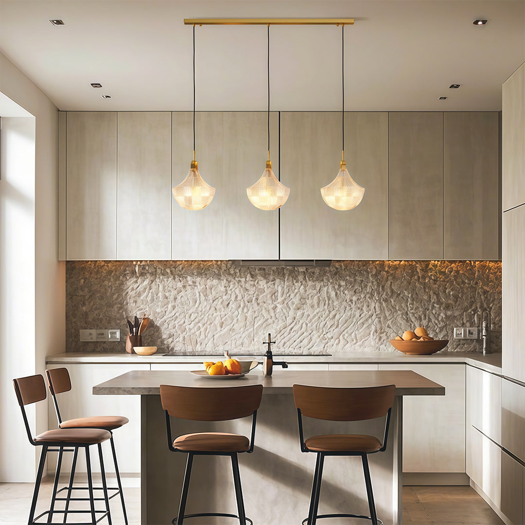 Shell chandelier light illuminating modern kitchen dining area with brown leather chairs.