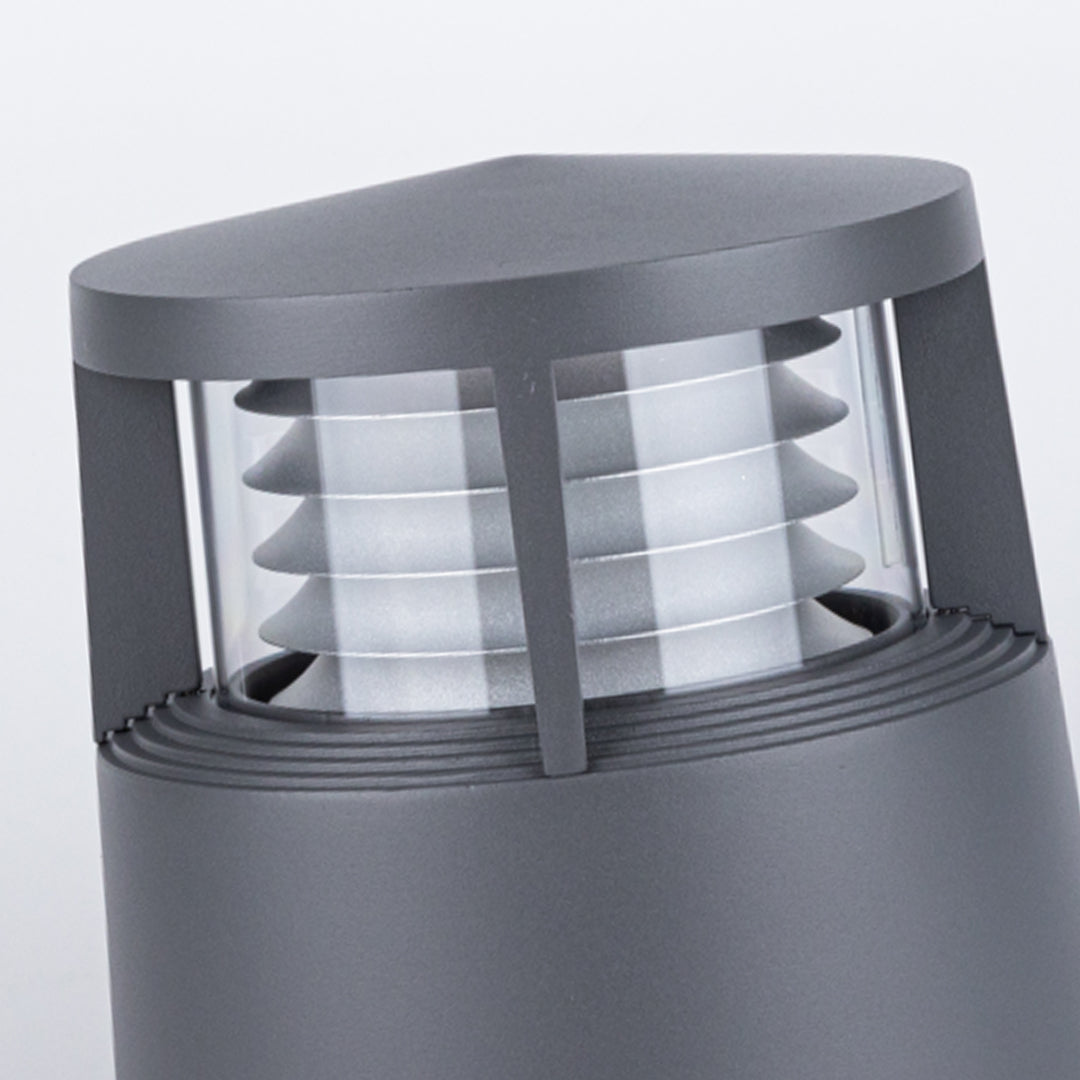 Close-up of contemporary short bollard light with aluminum housing and layered design