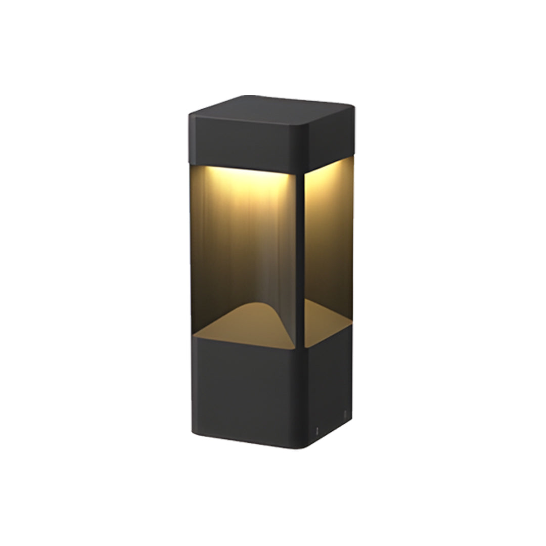 Short black square bollards lighting fixture with a warm white LED glow on white studio floor.
