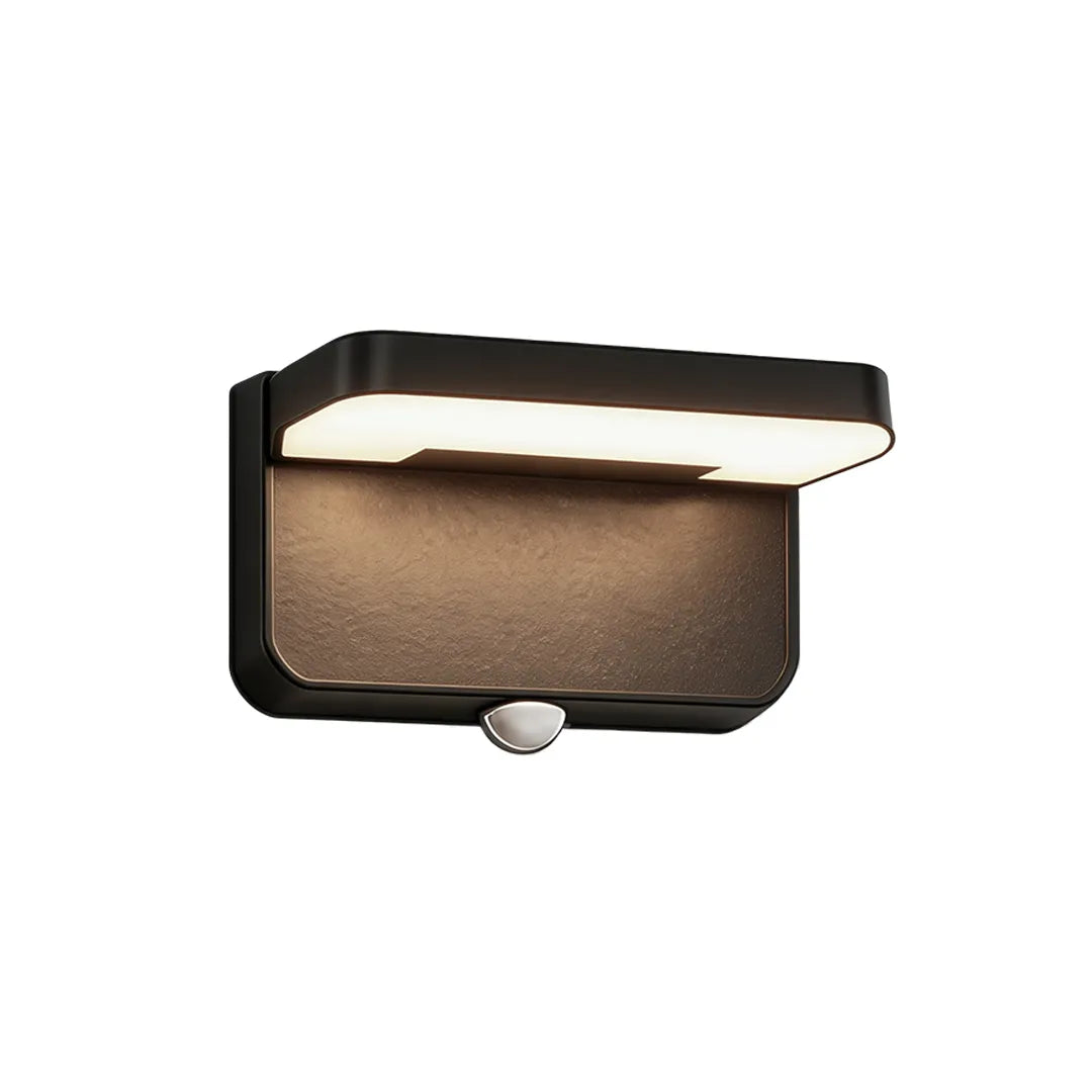 Short black outdoor wall light with motion sensor and warm LED illumination
