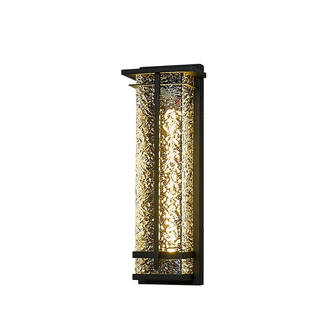 Short outdoor wall sconce with black frame textured glass and warm glow