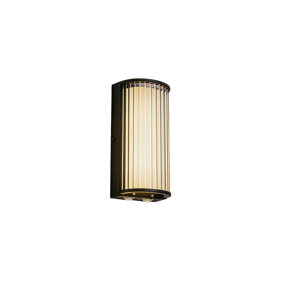 Short outdoor wall sconce with black frame ribbed glass and warm LED lighting