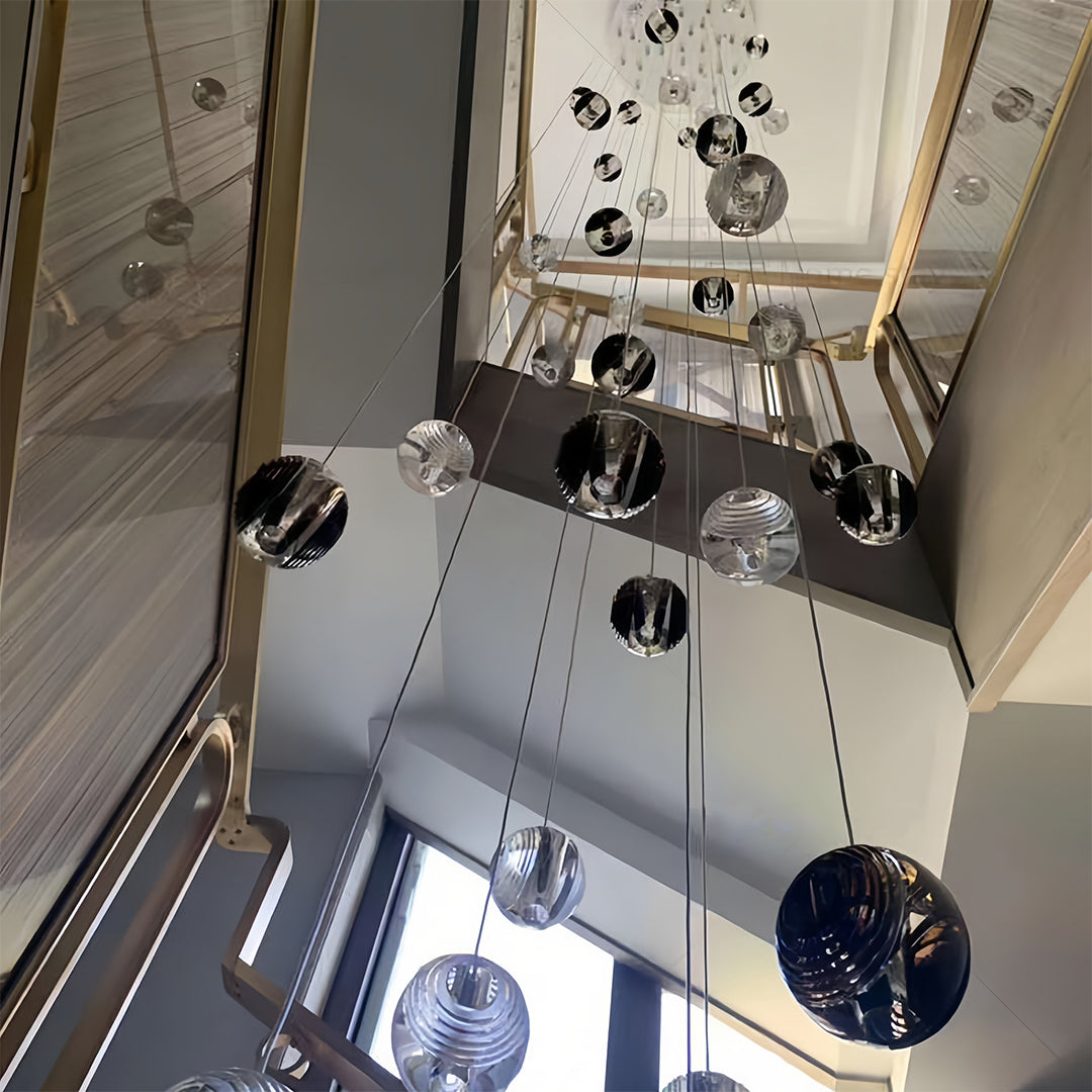 Showroom display of small black pendant lights demonstrating various mounting heights and arrangements