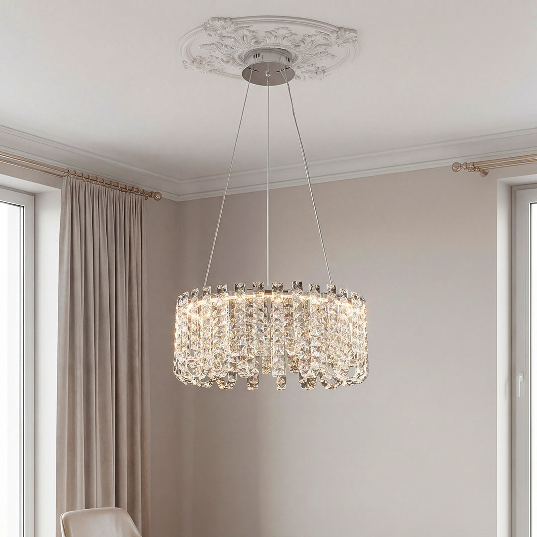 Elegant silver crystal chandelier modern design featuring a ring frame with cascading textured crystal prisms suspended from a decorative ceiling medallion.