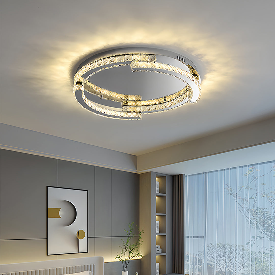 Silver flush mount ceiling light installed in modern bedroom creating warm atmospheric lighting