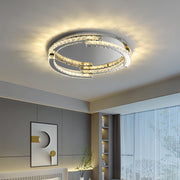 Silver flush mount ceiling light installed in modern bedroom creating warm atmospheric lighting