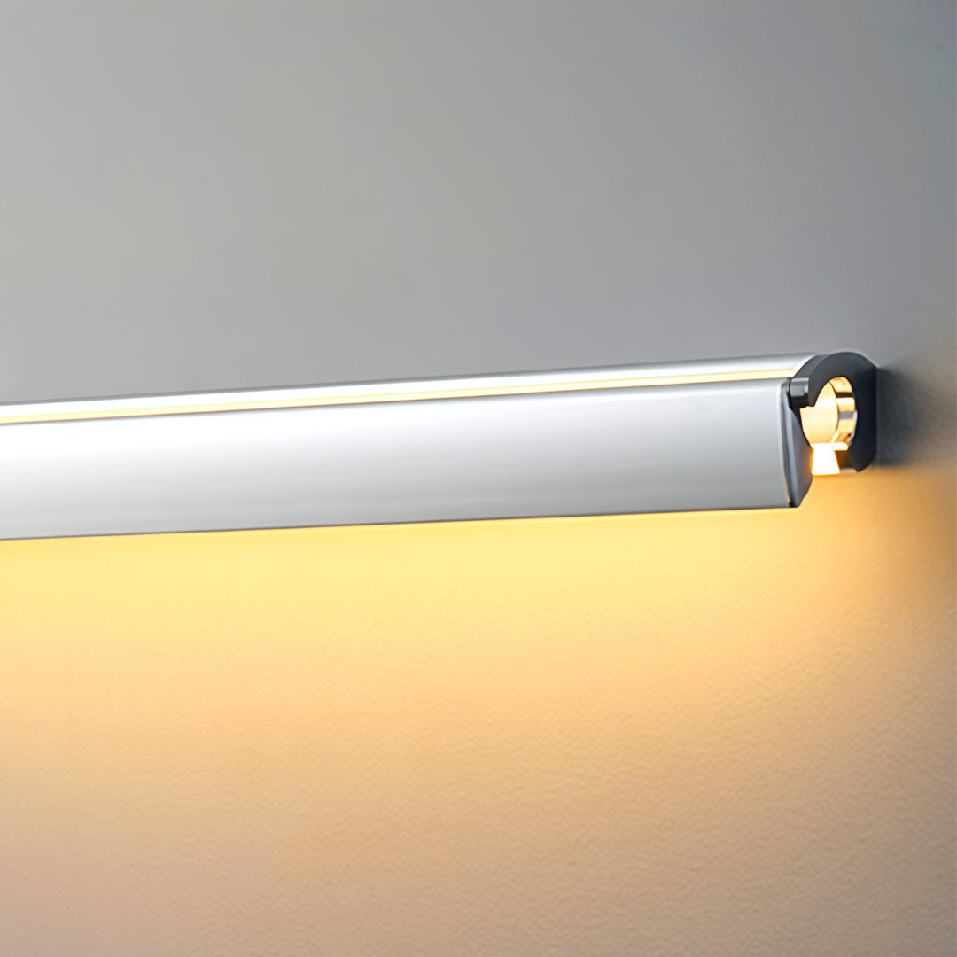 Detailed side angle of silver wall lights with cylindrical end cap and soft warm LED lighting effect.
