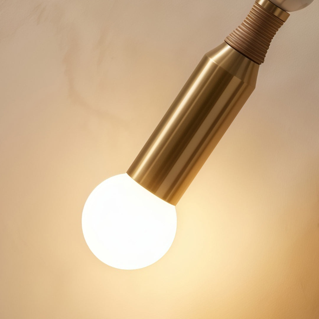 Close-up of silver wall lights featuring exposed round bulb and brushed metallic decorative detailing.