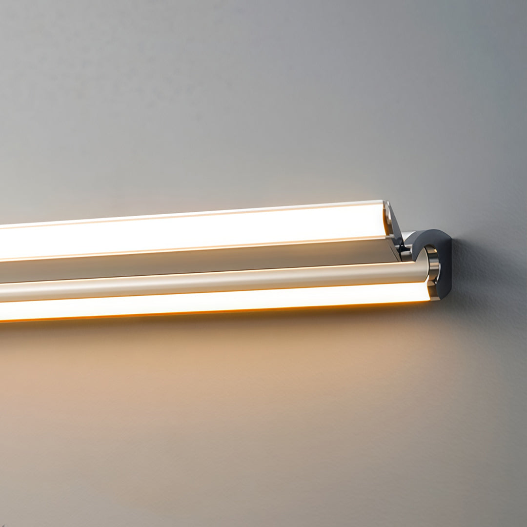 Close-up of sleek silver wall lights featuring slim linear LED construction and warm illuminated edge detail.