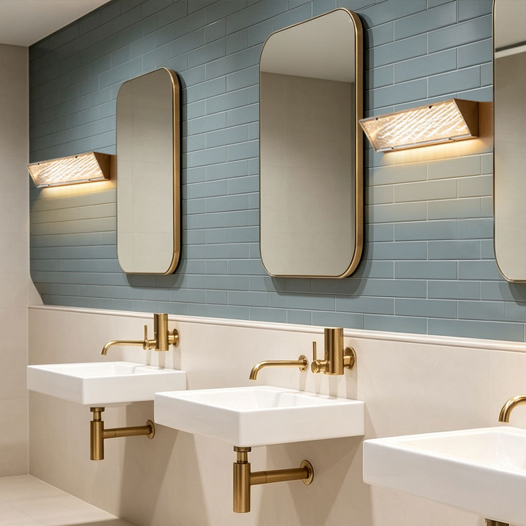 Contemporary silver wall lights beside bathroom mirrors with geometric shades in a stylish modern vanity space.