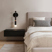 Modern silver wall lights beside a minimalist bedroom with exposed bulb design and warm ambient illumination.