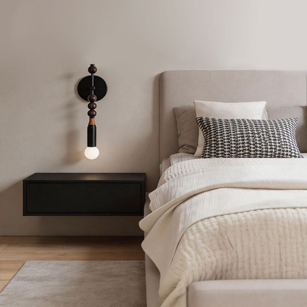 Modern silver wall lights beside a minimalist bedroom with exposed bulb design and warm ambient illumination.