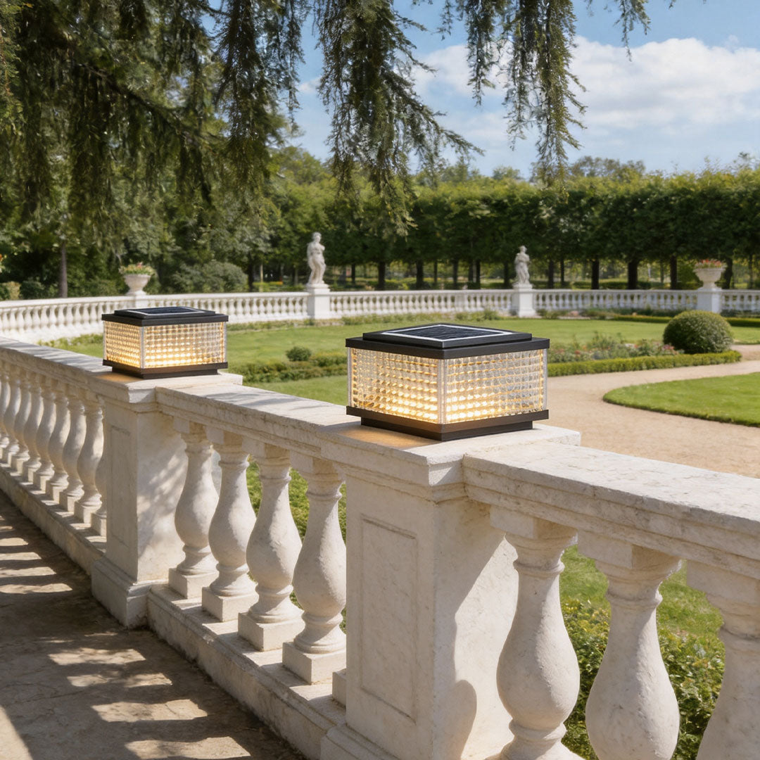 Elegant large outdoor solar pillar lights decorating luxury balcony railings in a bright landscaped outdoor setting.