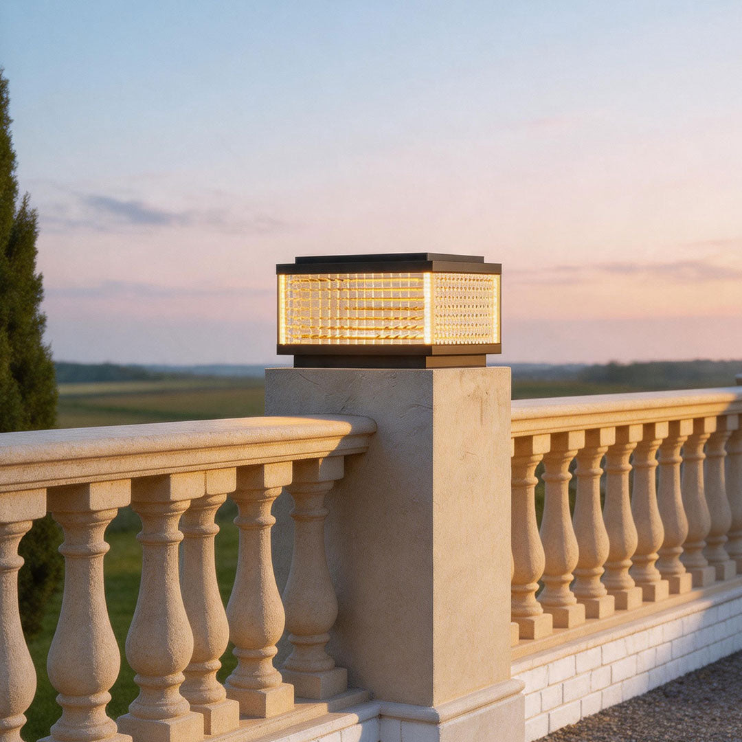 Contemporary large outdoor solar pillar lights illuminating a classic terrace railing during sunset ambiance.