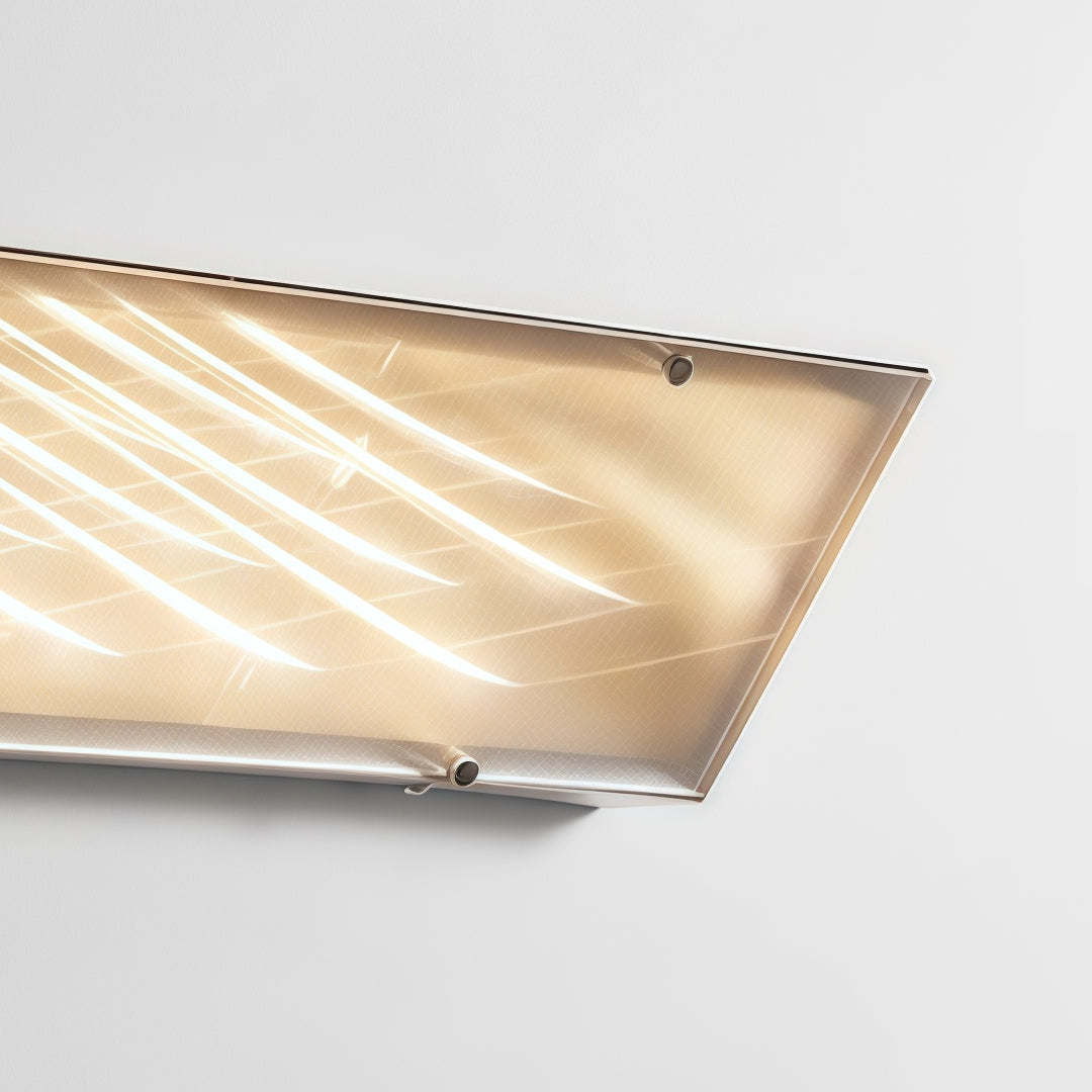 Close-up of textured silver wall lights with decorative geometric diffuser and warm LED illumination detail.