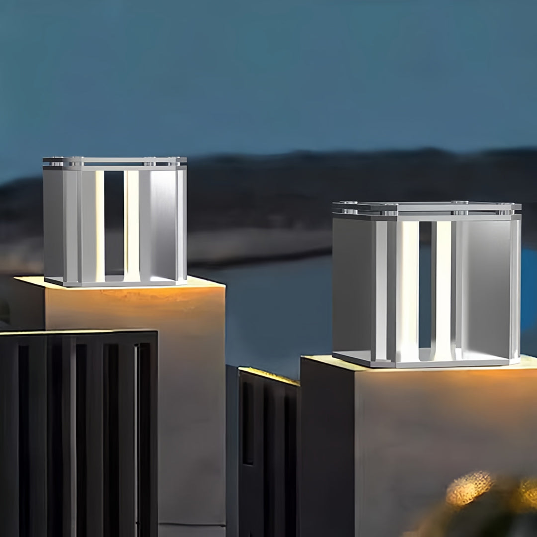 Contemporary silver main gate pillar light design installed on waterfront pillars for modern exteriors.