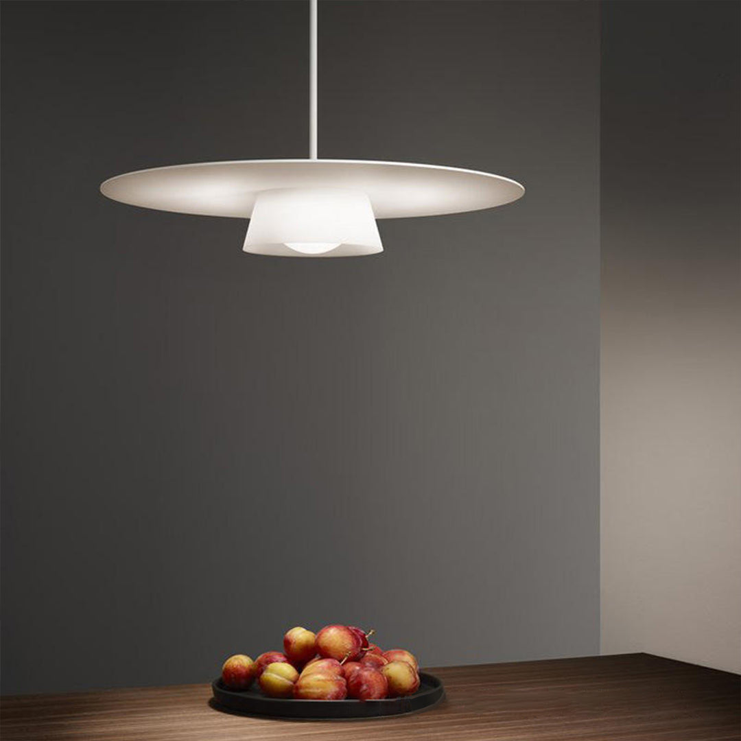 Single island pendant light fixtures illuminating dark modern interior with architectural elements