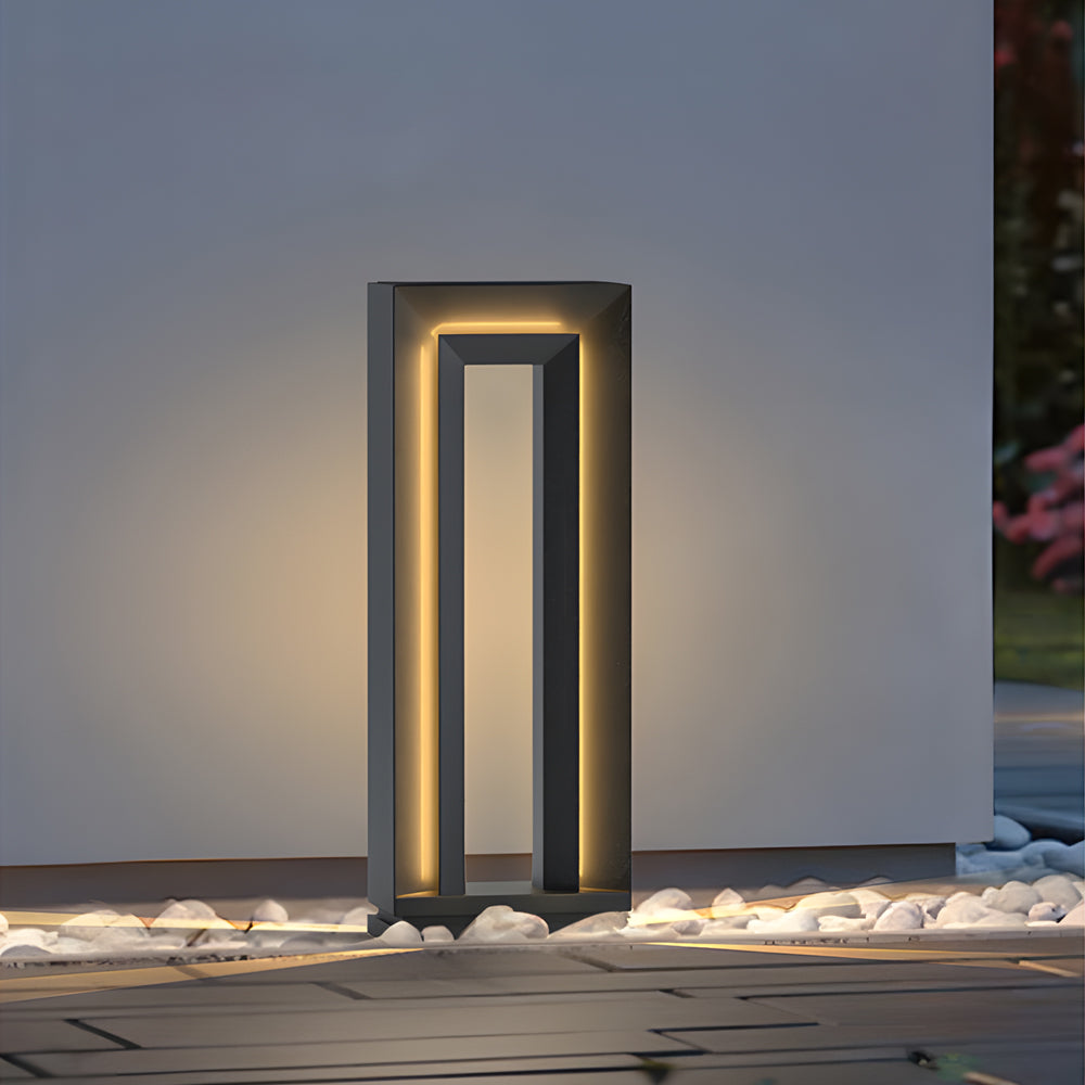 Single LED outdoor path light creating focused illumination on modern concrete pathway with clean architectural design