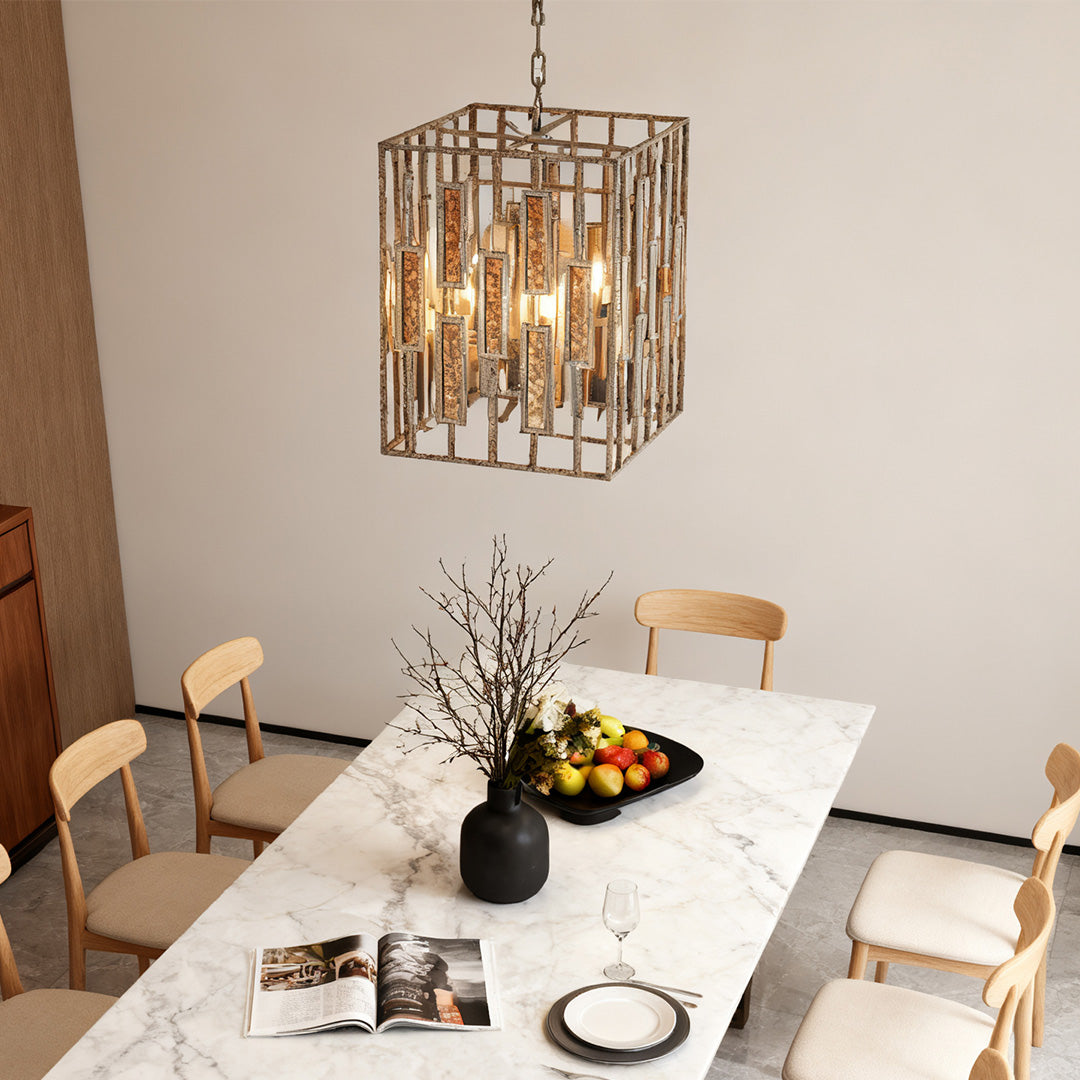 Single vintage copper pendant light fixture illuminating a modern white marble dining table and minimalist wood chairs.