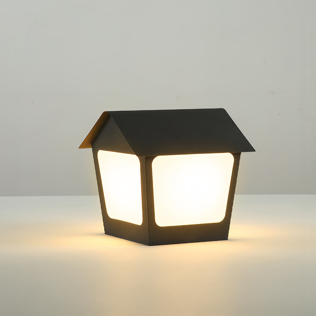 Single modern black deck post cap lights providing warm illumination, ideal for fence posts or exterior wall pillars.