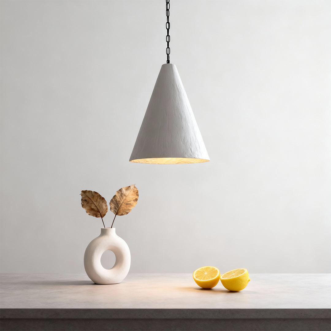 Single Nordic style pendant light illuminating minimalist dining setup with soft warm tone.