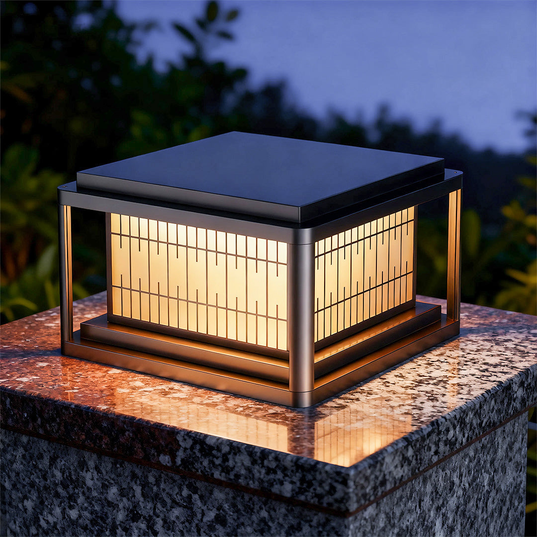 Single outdoor pillar LED light casting warm ambient glow on stone platform in evening garden setting.
