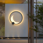 Single decorative outdoor wall light mounted on white exterior wall with warm ambient glow
