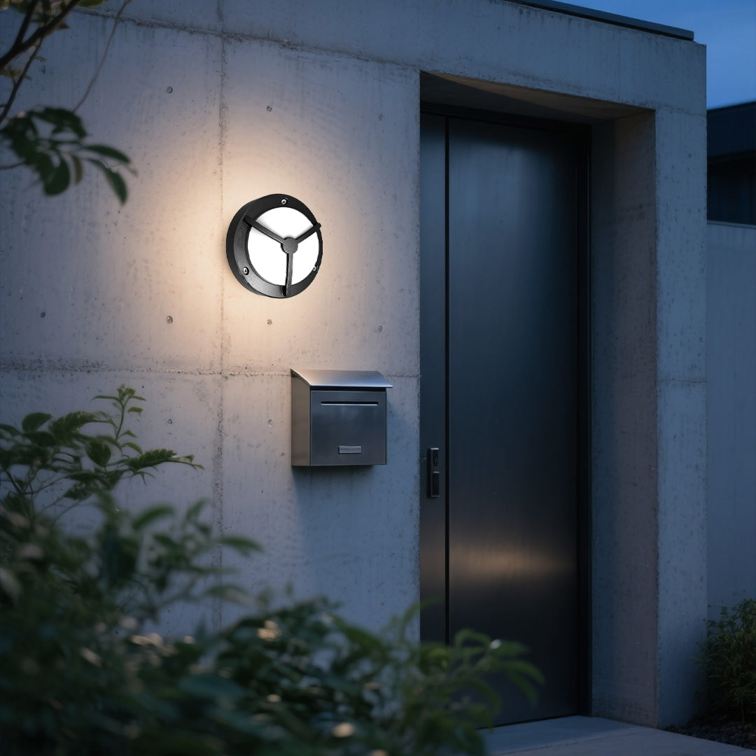 Single waterproof outdoor wall lighting creating ambient glow on white facade at dusk