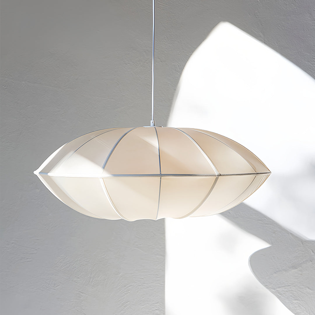Single fabric shade pendant light with clean white finish creating elegant room accent