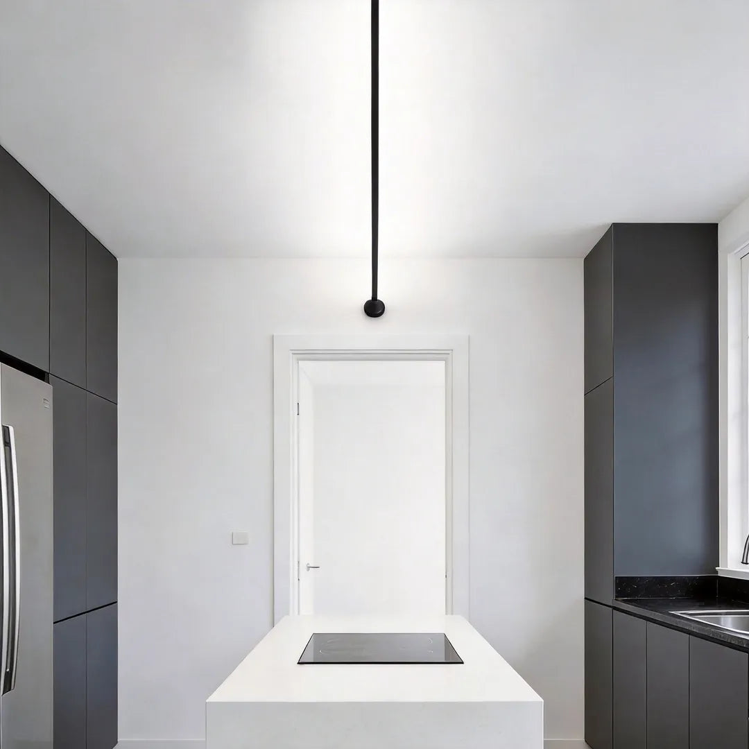 Skyline linear LED lighting suspended over a sleek kitchen island in a minimalist open-plan space.