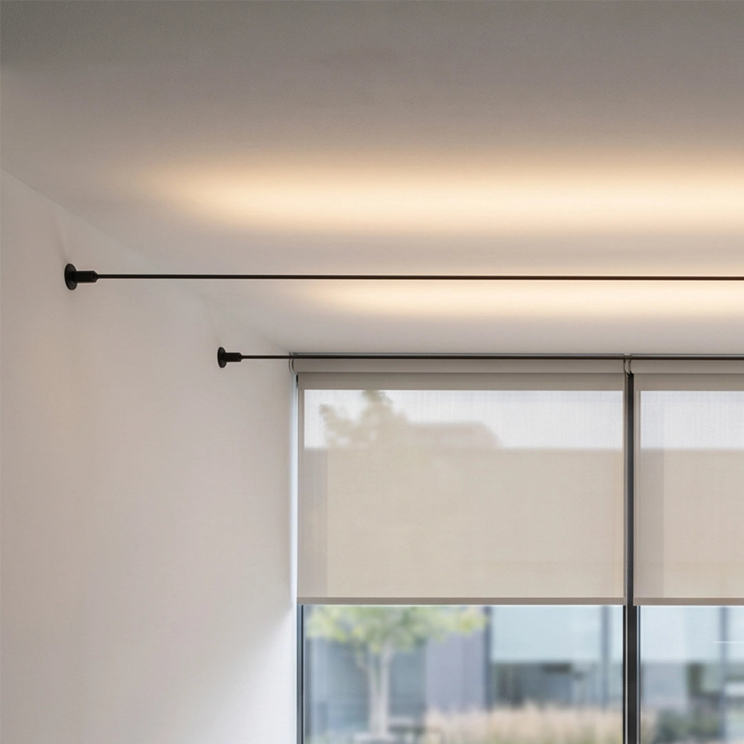 Close-up of skyline linear LED lighting mounted near a window, casting soft ambient light across the ceiling.