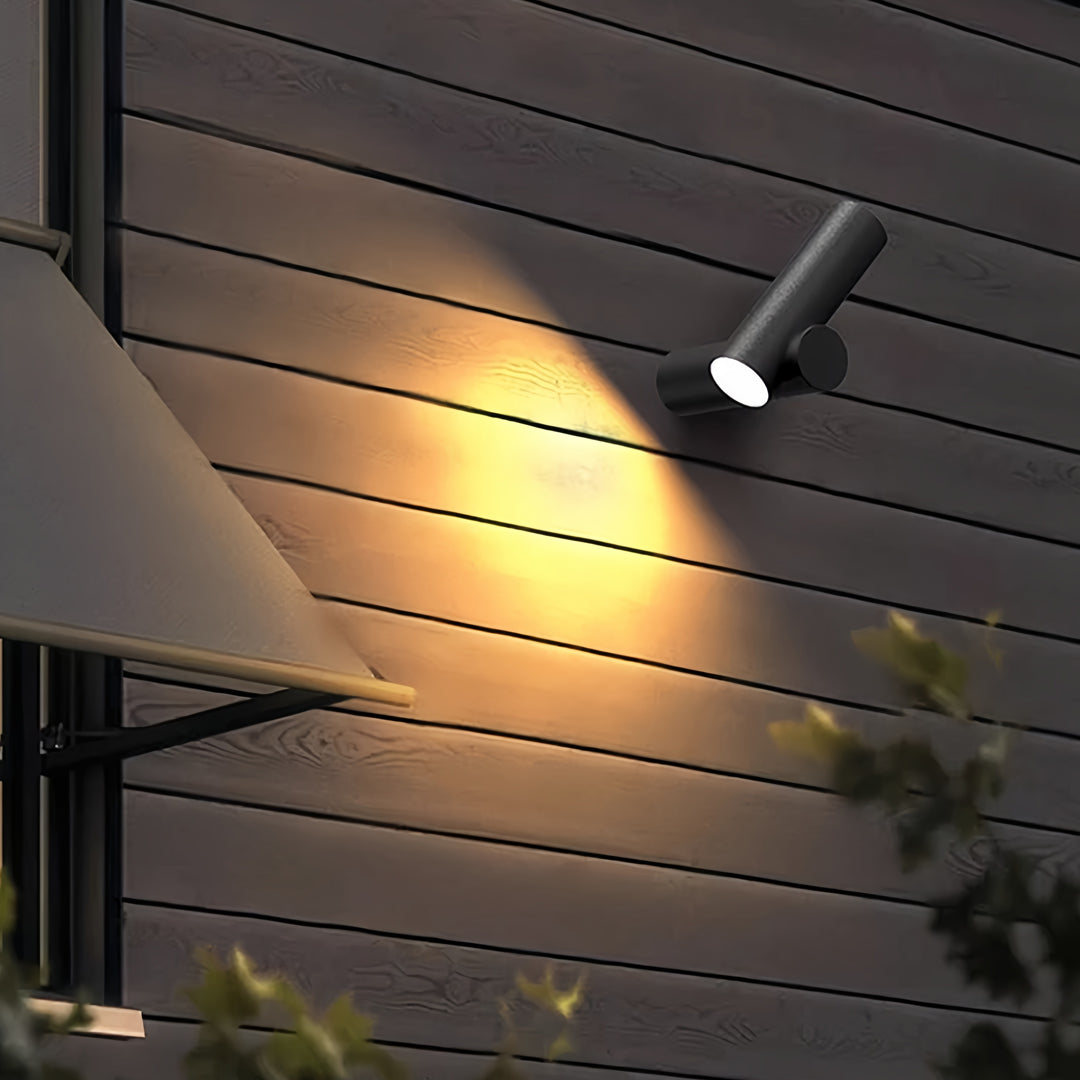 Outdoor spotlight wall lights installed on a slatted exterior wall, creating dramatic angled light patterns.
