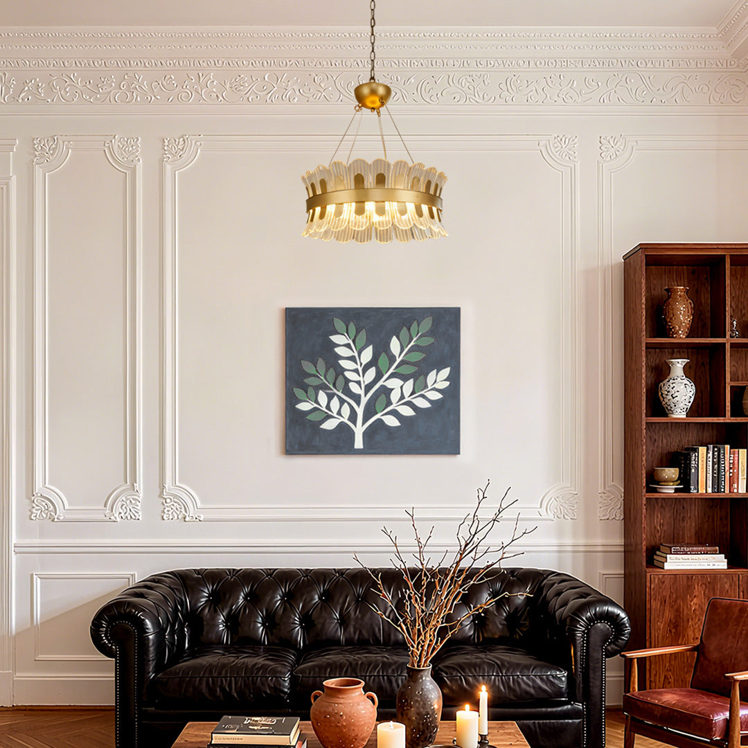 Classic gold candle-style chandelier in a refined study room with decorative art