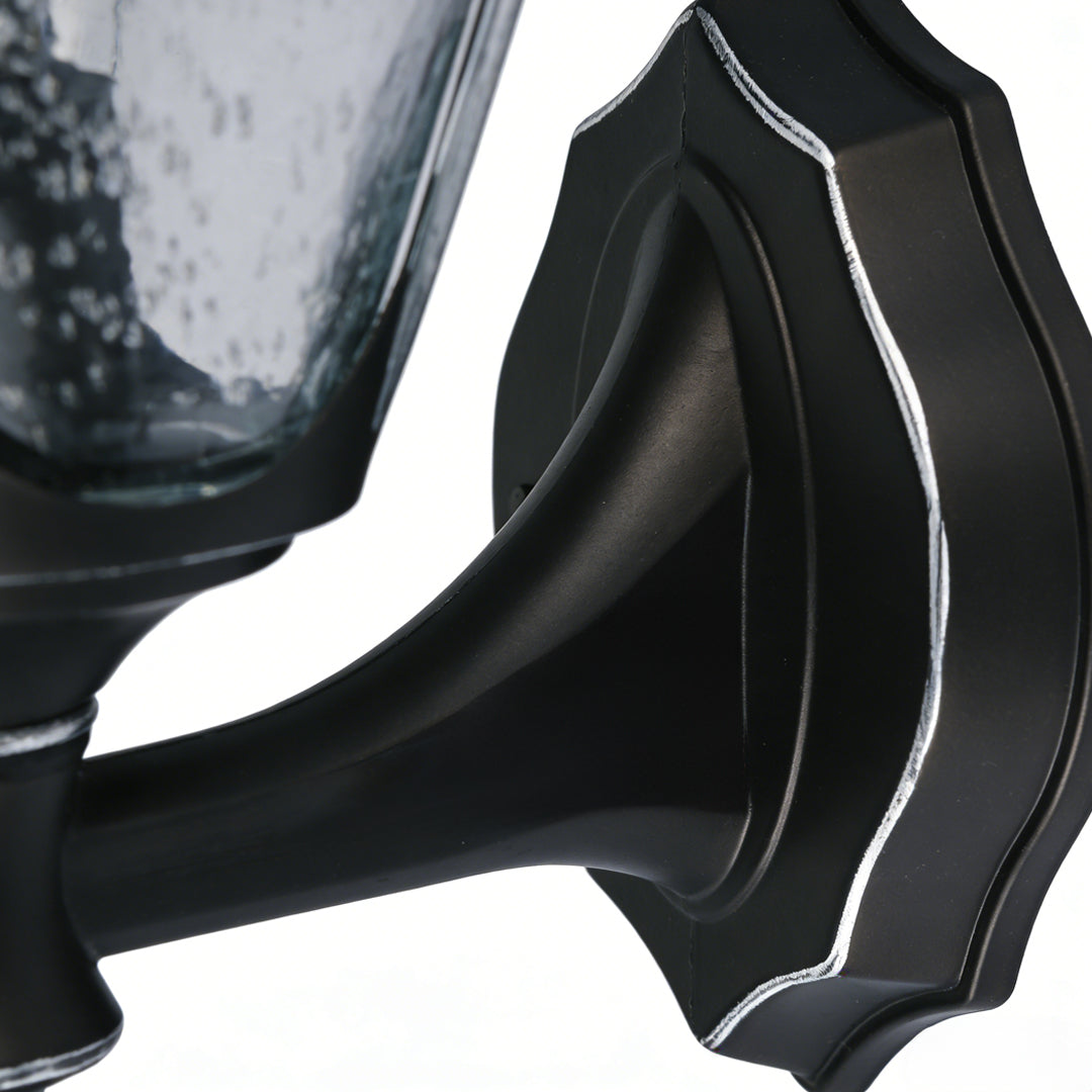 Modern outdoor light for wall featuring sleek black curved design and ribbed detailing, ideal for contemporary exterior spaces.