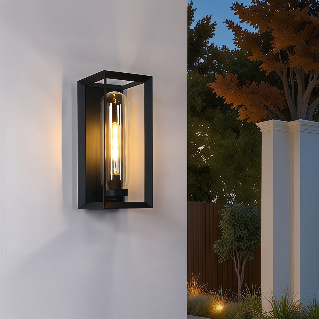 Sleek black outdoor wall sconce modern style illuminating contemporary residential exterior at dusk