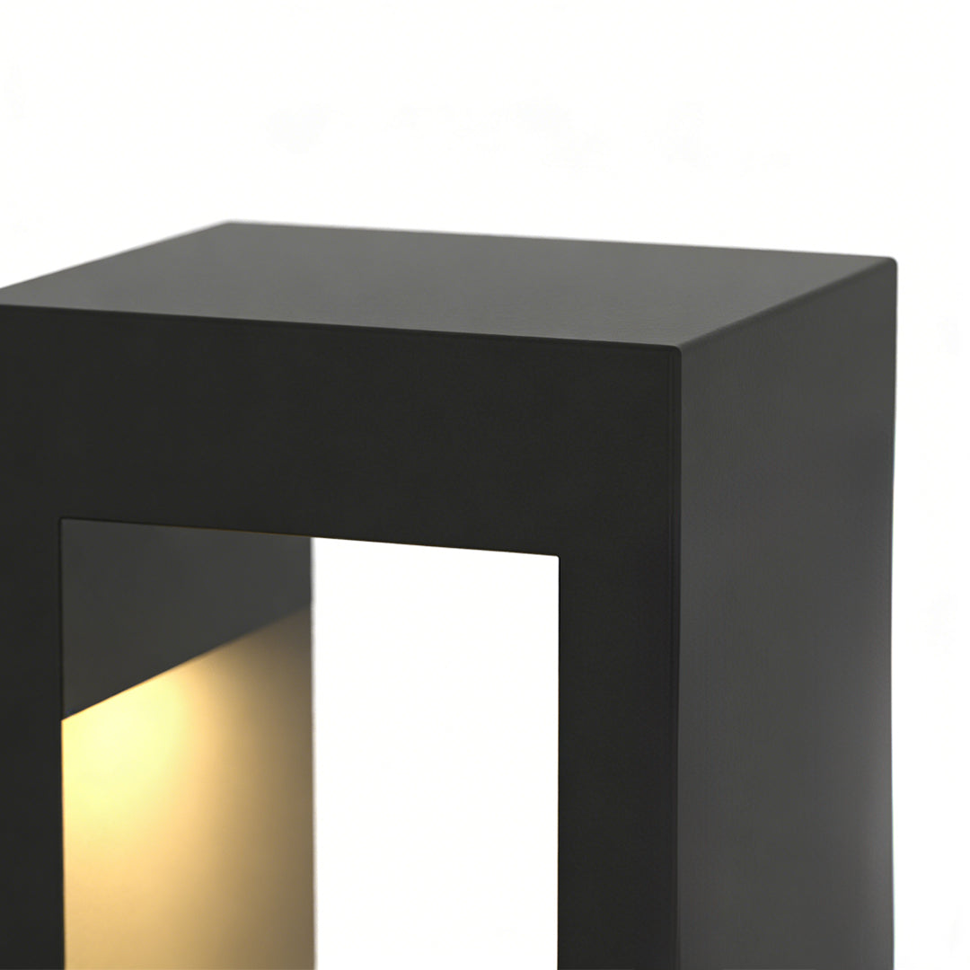Modern garden pathway lights featuring sleek black square design with warm interior glow, perfect for contemporary outdoor walkways.