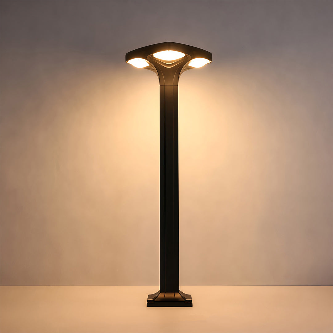 Sleek black outdoor wall light installed on a brick wall, providing bright lighting for the driveway.