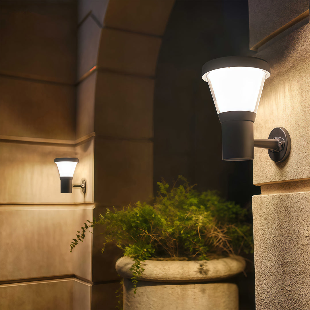 Sleek black wall light mounted next to a modern gate, lighting the path and yard area.