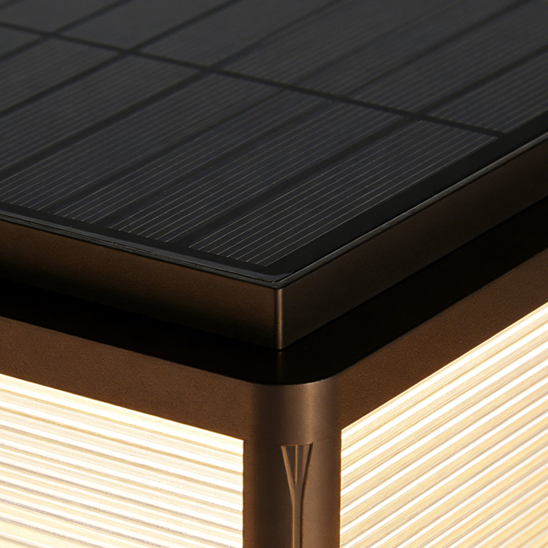 Modern outdoor patio pillar lights featuring sleek bronze top and textured surface, perfect for contemporary patio or deck illumination.