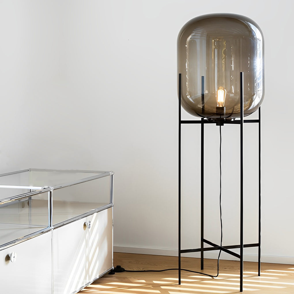 Sleek bubble glass floor lamp with a black metal base, placed in a minimalist living room.