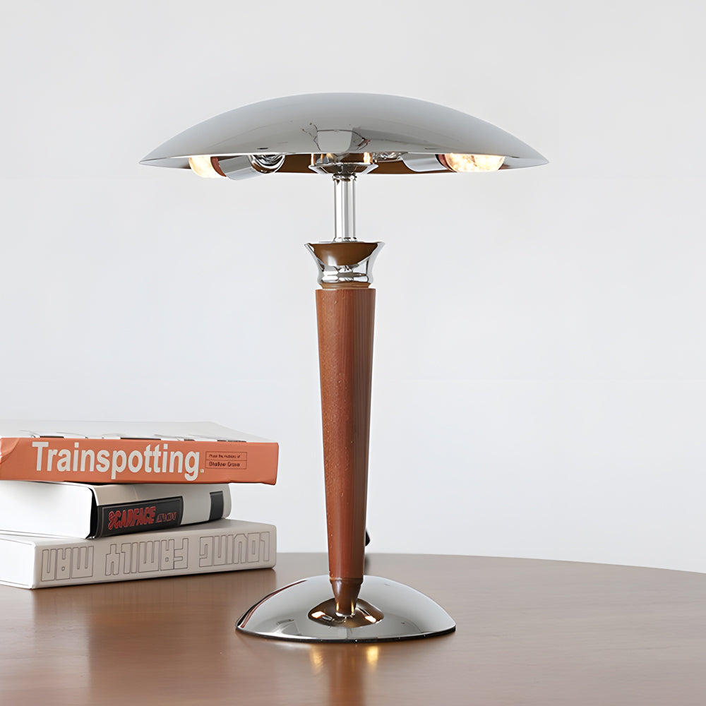 Sleek chrome mushroom lamp with wooden stem and modern shade on a minimalist wooden table.