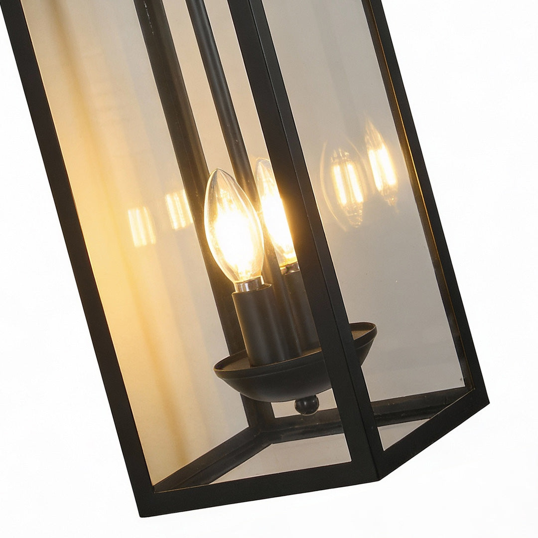 Sleek black external wall lights with clear glass panels and warm candle-style bulbs, perfect for stylish exterior ambiance.