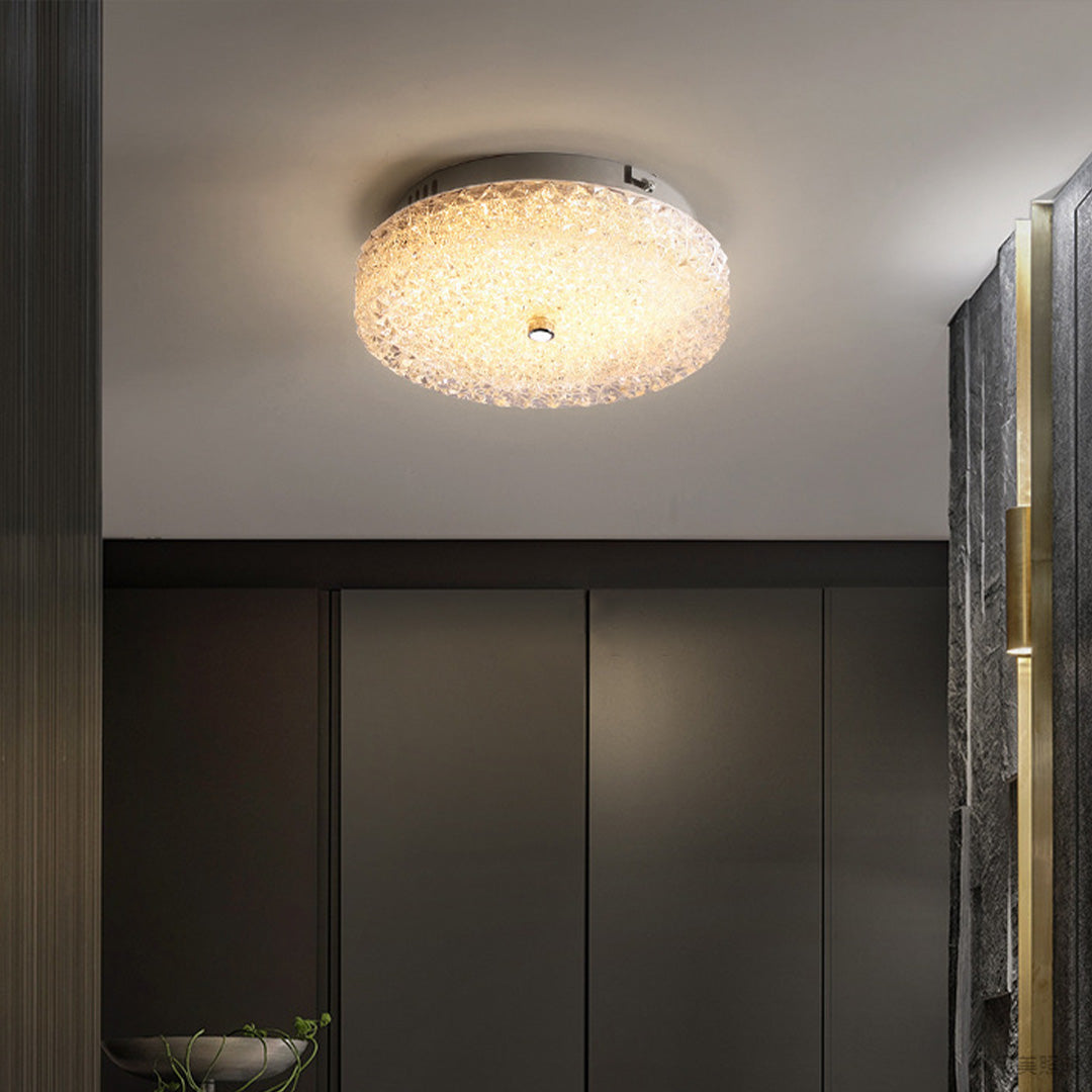 Modern flush mount crystal ceiling light adding a warm sparkle to a sleek dark cabinetry space.