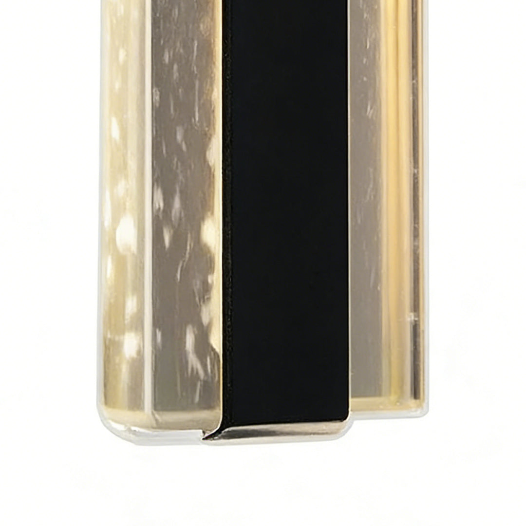 Sleek modern linear wall sconce with frosted glass and black center strip, providing elegant ambient illumination.